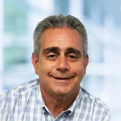Dr. John-Stephens portrait wearing a white and blue shirt.